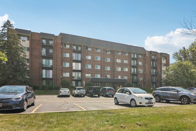 4711 Saint Joseph Creek Rd Unit 1E, Lisle, IL 60532 - view of apartment building / complex featuring uncovered parking