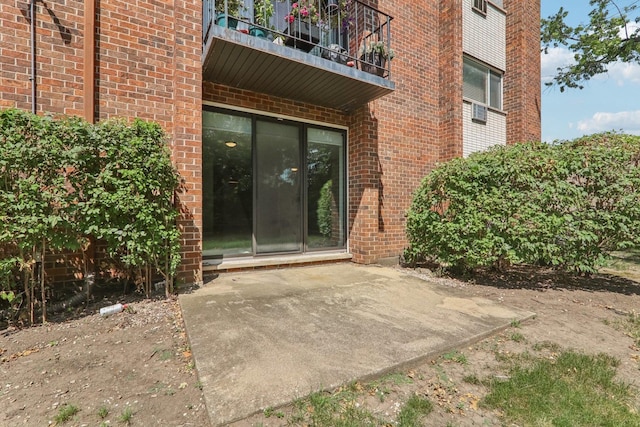 4711 Saint Joseph Creek Rd Unit 1E, Lisle, IL 60532 - entrance to property featuring brick siding, a balcony, and a patio area