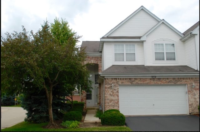 352 Bay Dr, Itasca, IL 60143 - view of front of home featuring brick siding, a garage, asphalt driveway, and a shingled roof