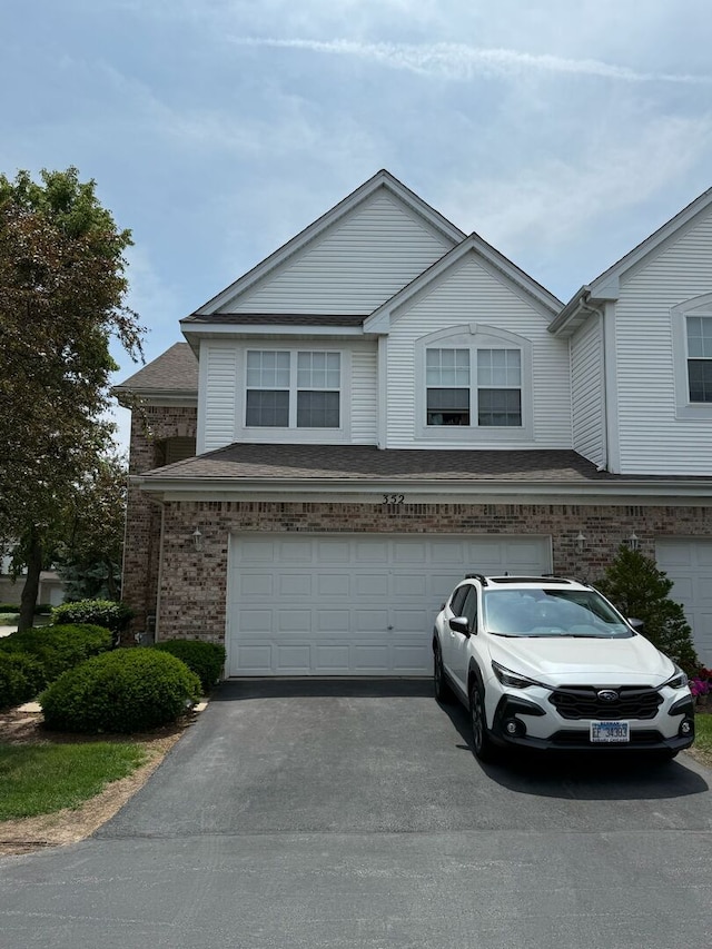 352 Bay Dr, Itasca, IL 60143 - multi unit property with an attached garage, asphalt driveway, and brick siding