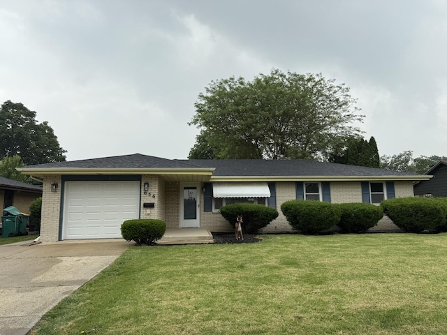 656 Springfield Ave, Joliet, IL 60435 - single story home with brick siding, a garage, concrete driveway, and a front yard