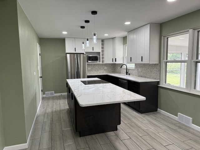 656 Springfield Ave, Joliet, IL 60435 - kitchen featuring appliances with stainless steel finishes, open shelves, wood finish floors, light stone countertops, and recessed lighting