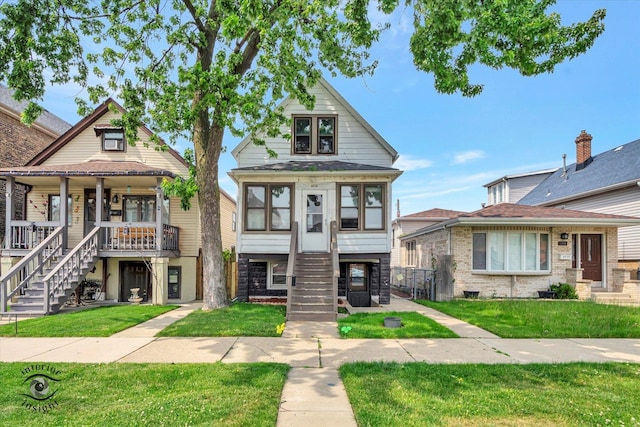 5716 W 64th Pl, Chicago, IL 60638 - view of front of property featuring stairs, a porch, and a front lawn