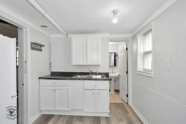 5716 W 64th Pl, Chicago, IL 60638 - kitchen featuring freestanding refrigerator, light wood-style flooring, white cabinetry, and dark countertops