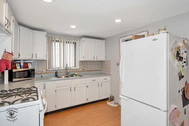 5716 W 64th Pl, Chicago, IL 60638 - kitchen with white appliances, tasteful backsplash, light countertops, white cabinets, and light wood-type flooring