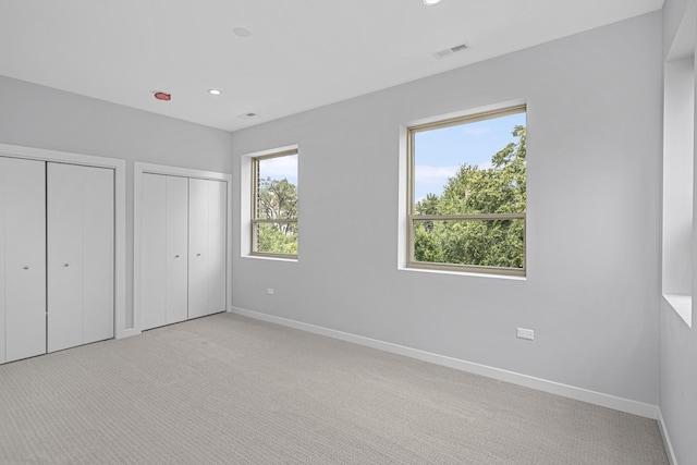 7239 S Exchange Ave, Chicago, IL 60649 - unfurnished bedroom with multiple closets, light colored carpet, and recessed lighting