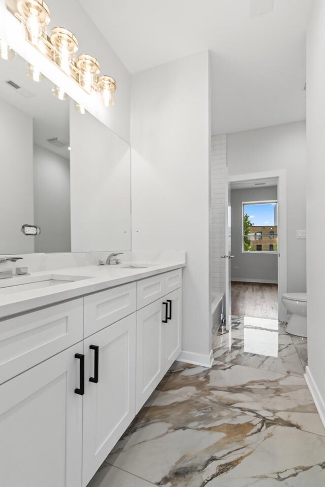 7239 S Exchange Ave, Chicago, IL 60649 - bathroom featuring double vanity and marble tiled flooring