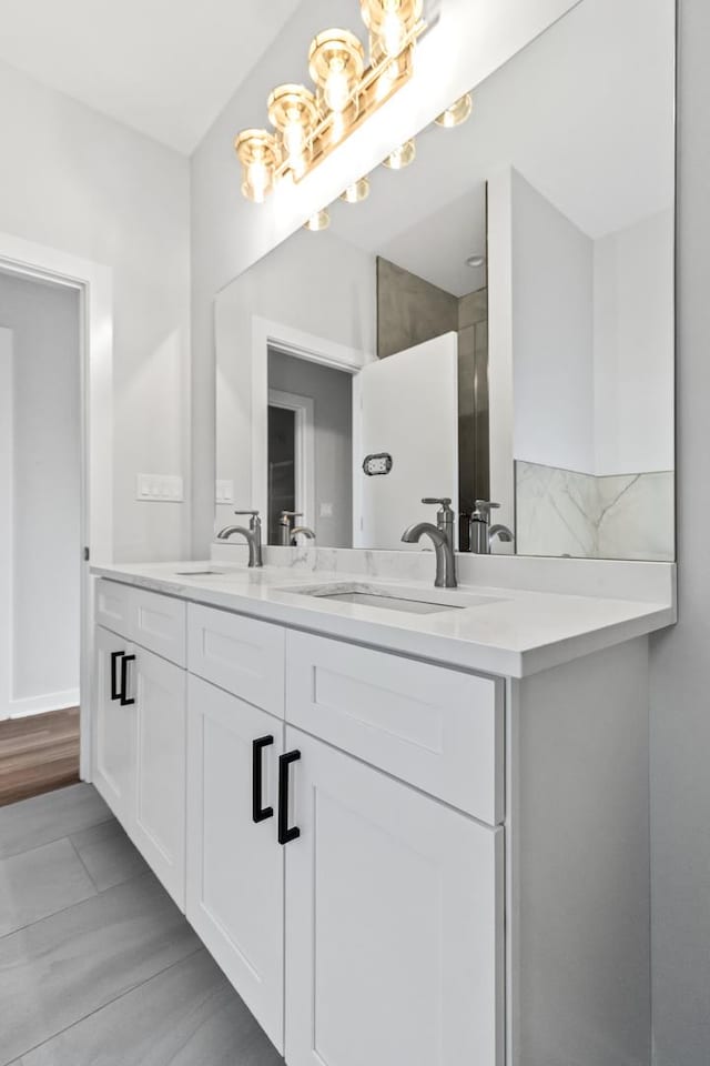 7239 S Exchange Ave, Chicago, IL 60649 - bathroom with double vanity and a chandelier