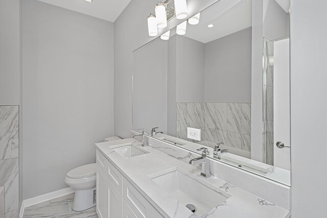 7239 S Exchange Ave, Chicago, IL 60649 - full bathroom with marble look tile flooring, double vanity, and recessed lighting