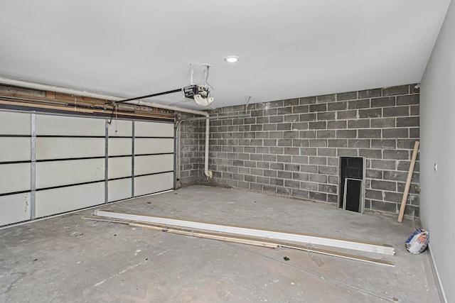7239 S Exchange Ave, Chicago, IL 60649 - garage featuring a garage door opener and concrete block wall