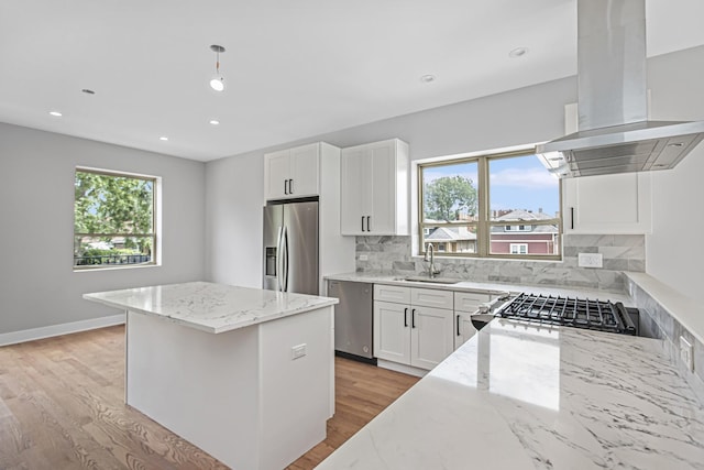 7239 S Exchange Ave, Chicago, IL 60649 - kitchen featuring island exhaust hood, stainless steel appliances, light stone counters, a kitchen island, and recessed lighting