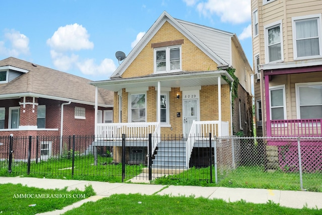 5029 W Superior St, Chicago, IL 60644 - view of front of house with brick siding, a porch, and a fenced front yard