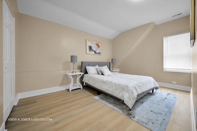 5029 W Superior St, Chicago, IL 60644 - bedroom with light wood-style floors and vaulted ceiling