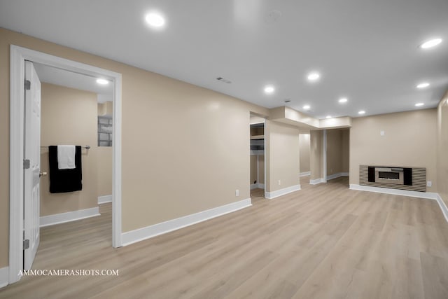 5029 W Superior St, Chicago, IL 60644 - unfurnished living room featuring light wood-type flooring, recessed lighting, and a glass covered fireplace