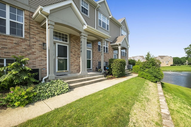 8004 Windsor Dr Unit 8004, Darien, IL 60561 - entrance to property featuring a lawn, a water view, and brick siding