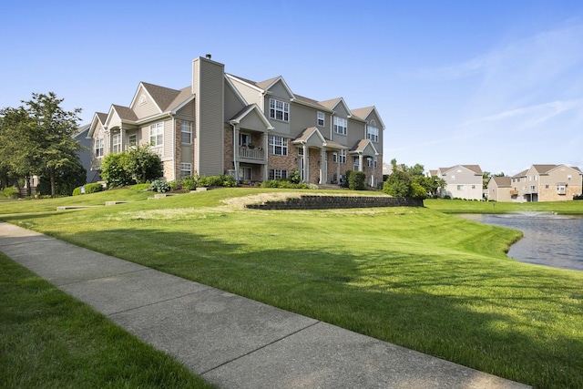 8004 Windsor Dr Unit 8004, Darien, IL 60561 - view of front of property featuring a front yard, a residential view, a water view, and brick siding
