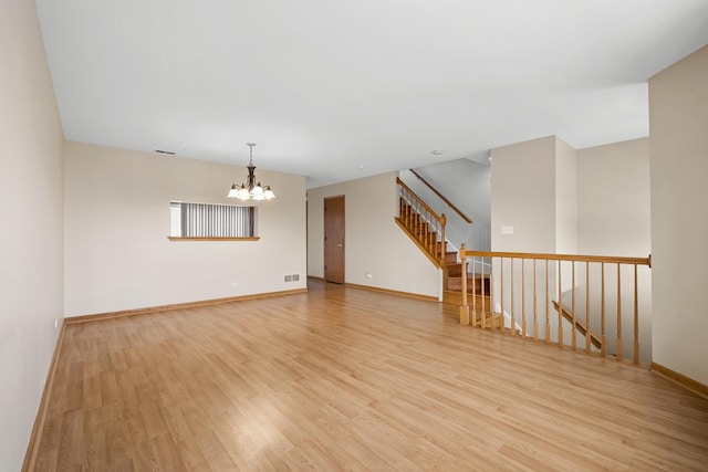8004 Windsor Dr Unit 8004, Darien, IL 60561 - empty room with light wood finished floors and a chandelier