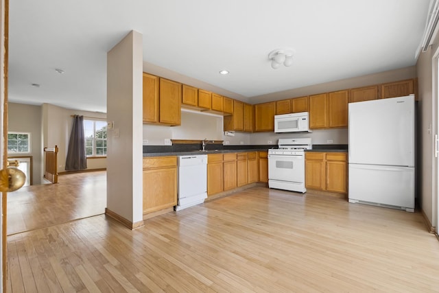 8004 Windsor Dr Unit 8004, Darien, IL 60561 - kitchen featuring white appliances, light wood-type flooring, dark countertops, and recessed lighting