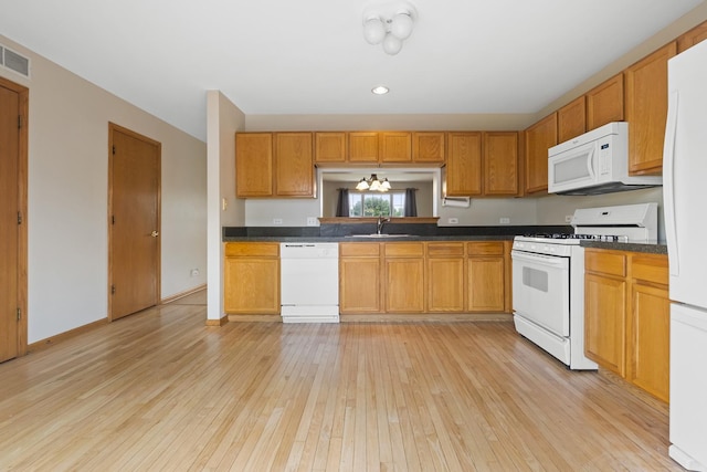 8004 Windsor Dr Unit 8004, Darien, IL 60561 - kitchen with white appliances, light wood-style flooring, dark countertops, brown cabinetry, and recessed lighting