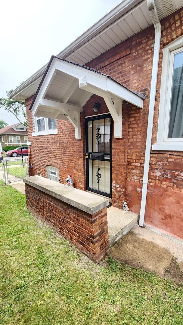 8127 S Blackstone Ave, Chicago, IL 60619 - doorway to property featuring brick siding