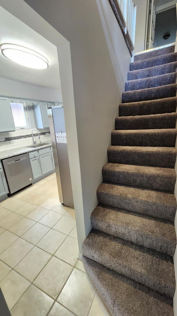 8127 S Blackstone Ave, Chicago, IL 60619 - staircase with tile patterned flooring