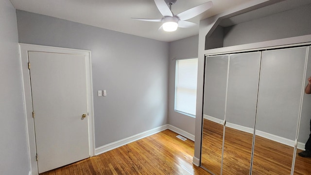 8127 S Blackstone Ave, Chicago, IL 60619 - unfurnished bedroom featuring wood finished floors, a closet, and ceiling fan