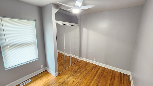8127 S Blackstone Ave, Chicago, IL 60619 - unfurnished bedroom with light wood-type flooring, a closet, and a ceiling fan