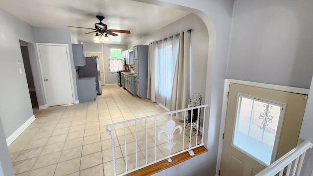 8127 S Blackstone Ave, Chicago, IL 60619 - kitchen featuring freestanding refrigerator, gray cabinetry, ceiling fan, and arched walkways