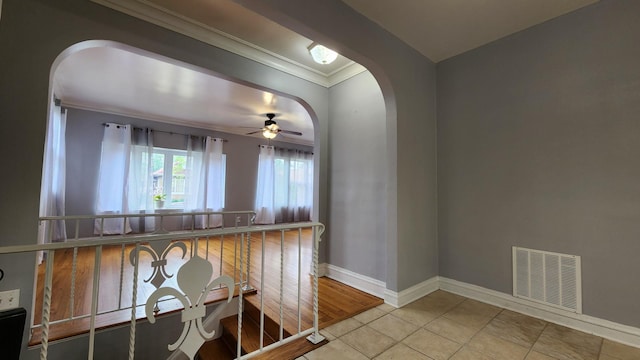 8127 S Blackstone Ave, Chicago, IL 60619 - tiled spare room featuring arched walkways, ceiling fan, and crown molding