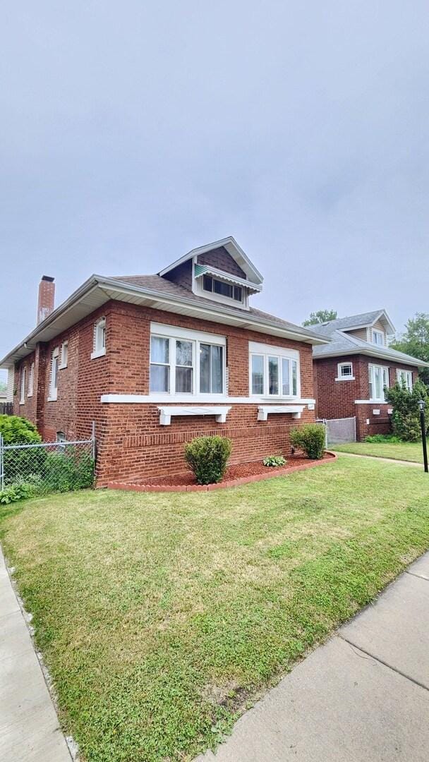 8127 S Blackstone Ave, Chicago, IL 60619 - view of front of home featuring brick siding and a chimney