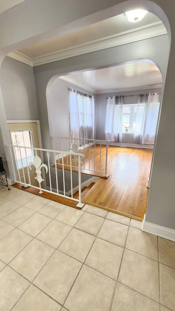 8127 S Blackstone Ave, Chicago, IL 60619 - tiled spare room with ornamental molding and arched walkways