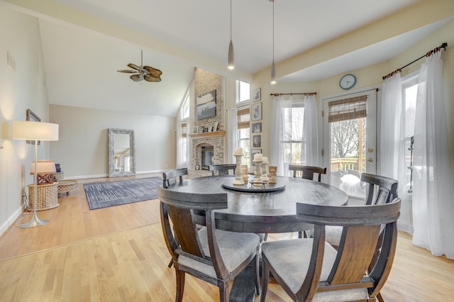 1218 Birchdale Ln, Aurora, IL 60504 - dining space featuring ceiling fan, a brick fireplace, light wood-style floors, high vaulted ceiling, and beamed ceiling