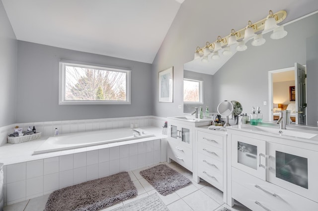 1218 Birchdale Ln, Aurora, IL 60504 - full bathroom with double vanity, vaulted ceiling, a bath, and tile patterned flooring
