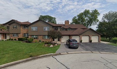 7930 W Lakeview Ct Unit 2A, Palos Heights, IL 60463 - view of front of property featuring asphalt driveway, a front lawn, a garage, and a chimney