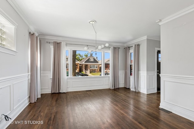 5155 W George St, Chicago, IL 60641 - unfurnished dining area featuring a decorative wall, wood finished floors, wainscoting, and ornamental molding