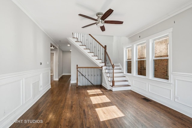 5155 W George St, Chicago, IL 60641 - foyer entrance with ceiling fan, wood finished floors, crown molding, a wainscoted wall, and stairs