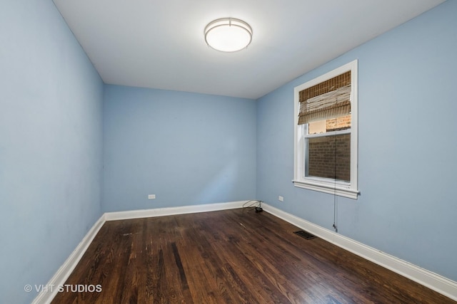 5155 W George St, Chicago, IL 60641 - unfurnished room with dark wood finished floors and baseboards