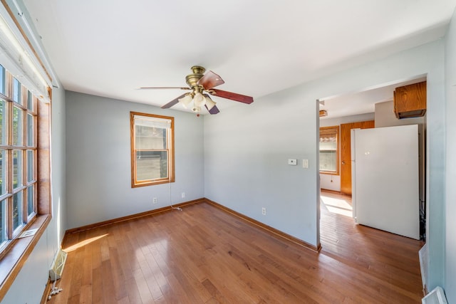 557 E Mckinley St, Hinckley, IL 60520 - unfurnished room featuring healthy amount of natural light, a ceiling fan, and hardwood / wood-style floors