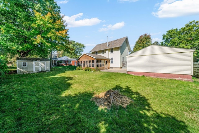 557 E Mckinley St, Hinckley, IL 60520 - view of green lawn featuring a sunroom, a patio, and a storage shed
