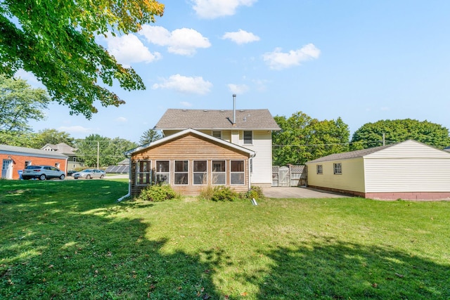 557 E Mckinley St, Hinckley, IL 60520 - back of house with a sunroom, a lawn, and a patio area