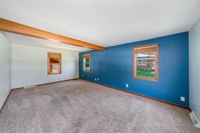 557 E Mckinley St, Hinckley, IL 60520 - carpeted empty room featuring baseboards and beam ceiling