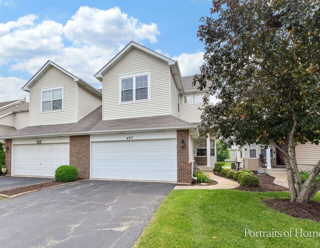 497 Le Moyne Ave, Romeoville, IL 60446 - view of front of house featuring brick siding, asphalt driveway, a garage, and a front yard