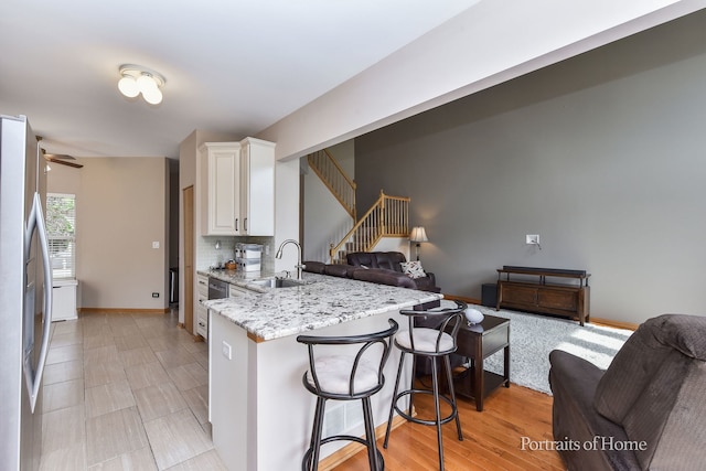 497 Le Moyne Ave, Romeoville, IL 60446 - kitchen with open floor plan, stainless steel refrigerator with ice dispenser, a peninsula, and a kitchen breakfast bar