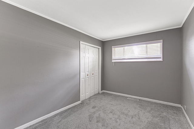 431 Lakewood Blvd, Park Forest, IL 60466 - unfurnished bedroom featuring crown molding, a closet, and carpet