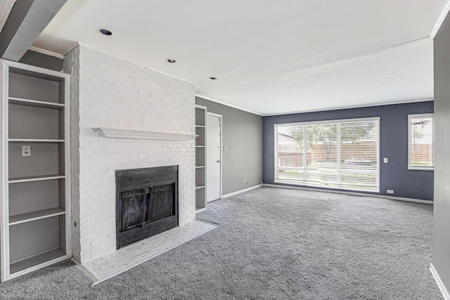 431 Lakewood Blvd, Park Forest, IL 60466 - unfurnished living room featuring built in features, ornamental molding, carpet flooring, and a brick fireplace