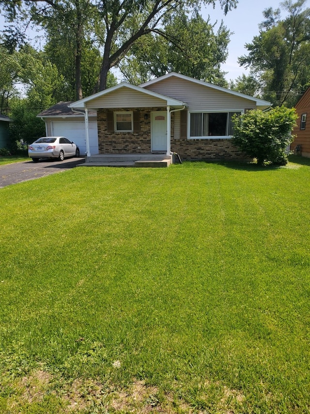 4917 Prairie Ave, Mchenry, IL 60050 - view of front facade featuring driveway, a front yard, a porch, and a garage