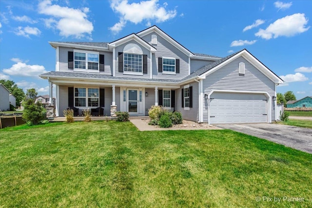 911 Water Stone Way, Malta, IL 60150 - view of front facade featuring asphalt driveway, an attached garage, covered porch, and a front yard