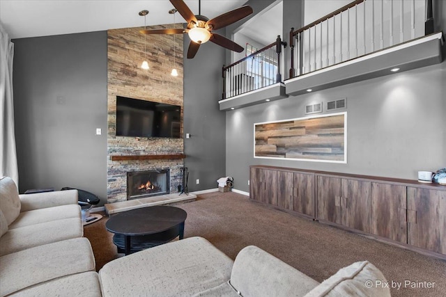911 Water Stone Way, Malta, IL 60150 - carpeted living area with high vaulted ceiling, ceiling fan, and a stone fireplace