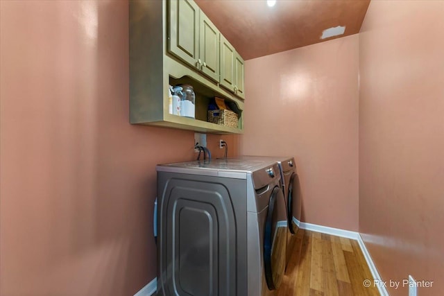 911 Water Stone Way, Malta, IL 60150 - washroom with cabinet space, washer and dryer, and light wood-style floors
