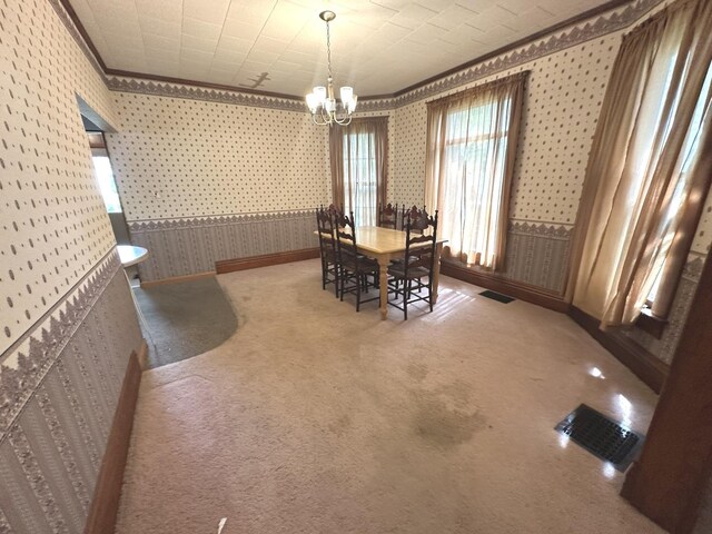 506 E Lincoln St, Saybrook, IL 61770 - carpeted dining room with wallpapered walls, ornamental molding, and a chandelier